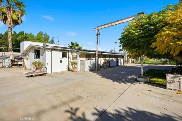 a view of a house with backyard porch and sitting area