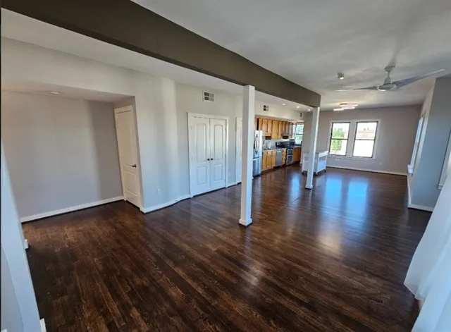 a view of a room with wooden floor