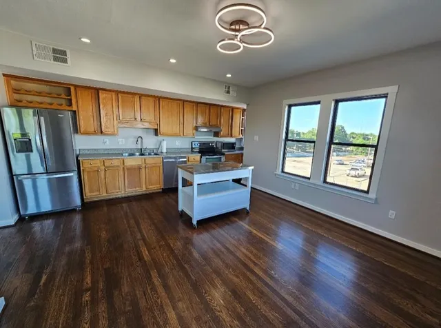 a living room with wooden floor and a table