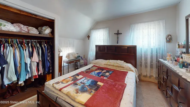 a bedroom with a bed and a closet