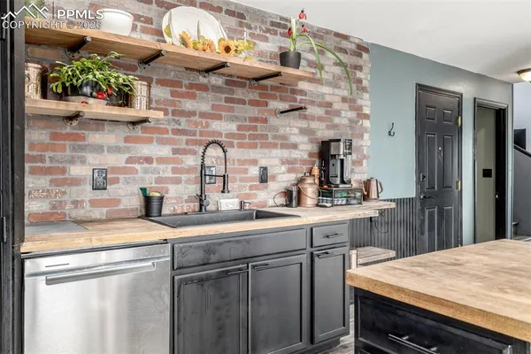 a kitchen with a sink and a refrigerator