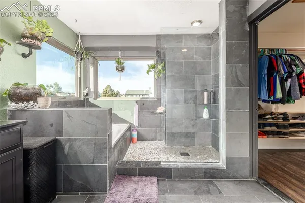 a bathroom with a glass shower door and a bathtub