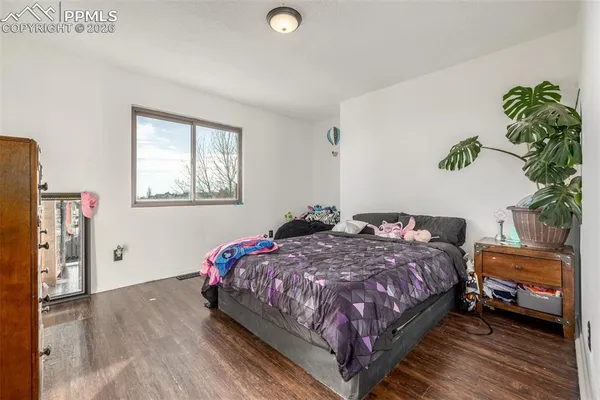 a bedroom with a bed plant and a window