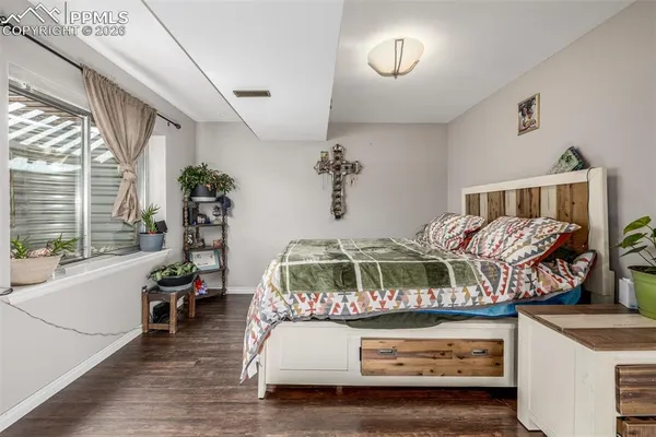 a bedroom with furniture and a wooden floor