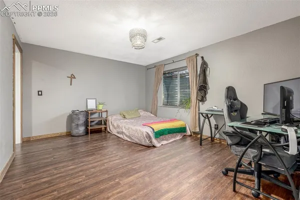 a bedroom with a bed and a desk