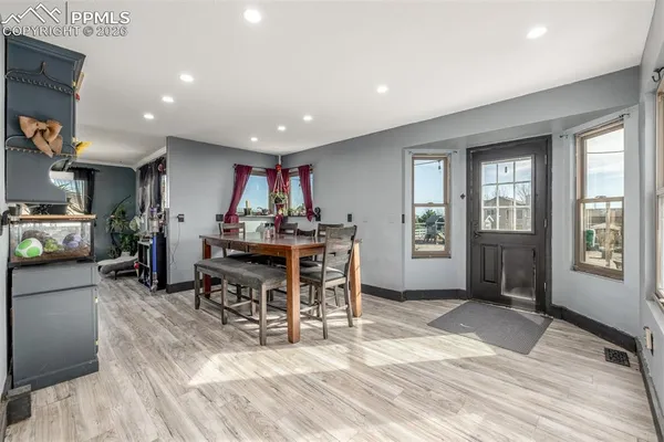 a view of a dining room with furniture window and wooden floor