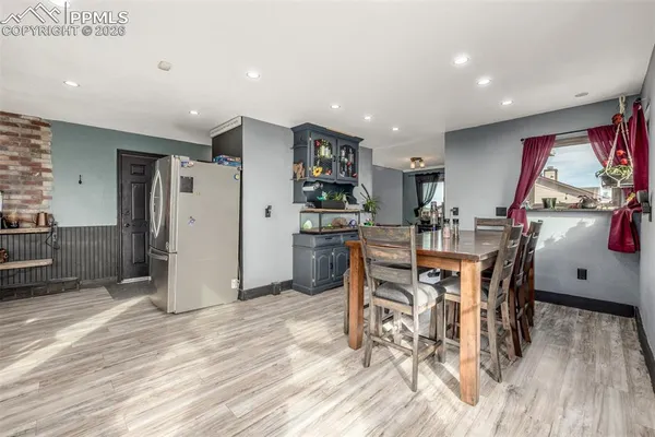 a view of a dining room with furniture and wooden floor