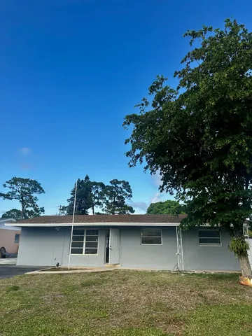 a kitchen with stainless steel appliances granite countertop a sink and a refrigerator