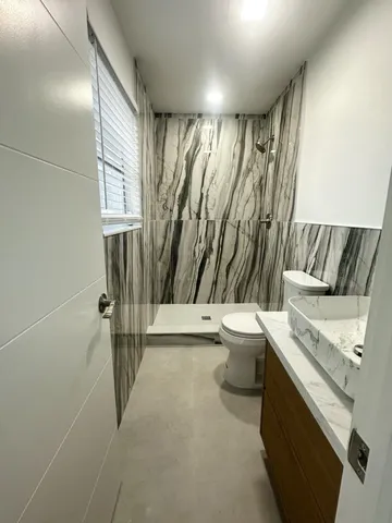 a bathroom with a toilet and a shower curtain