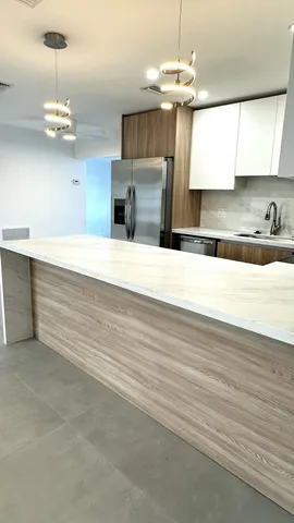 a kitchen with stainless steel appliances granite countertop a sink a stove a microwave and cabinets