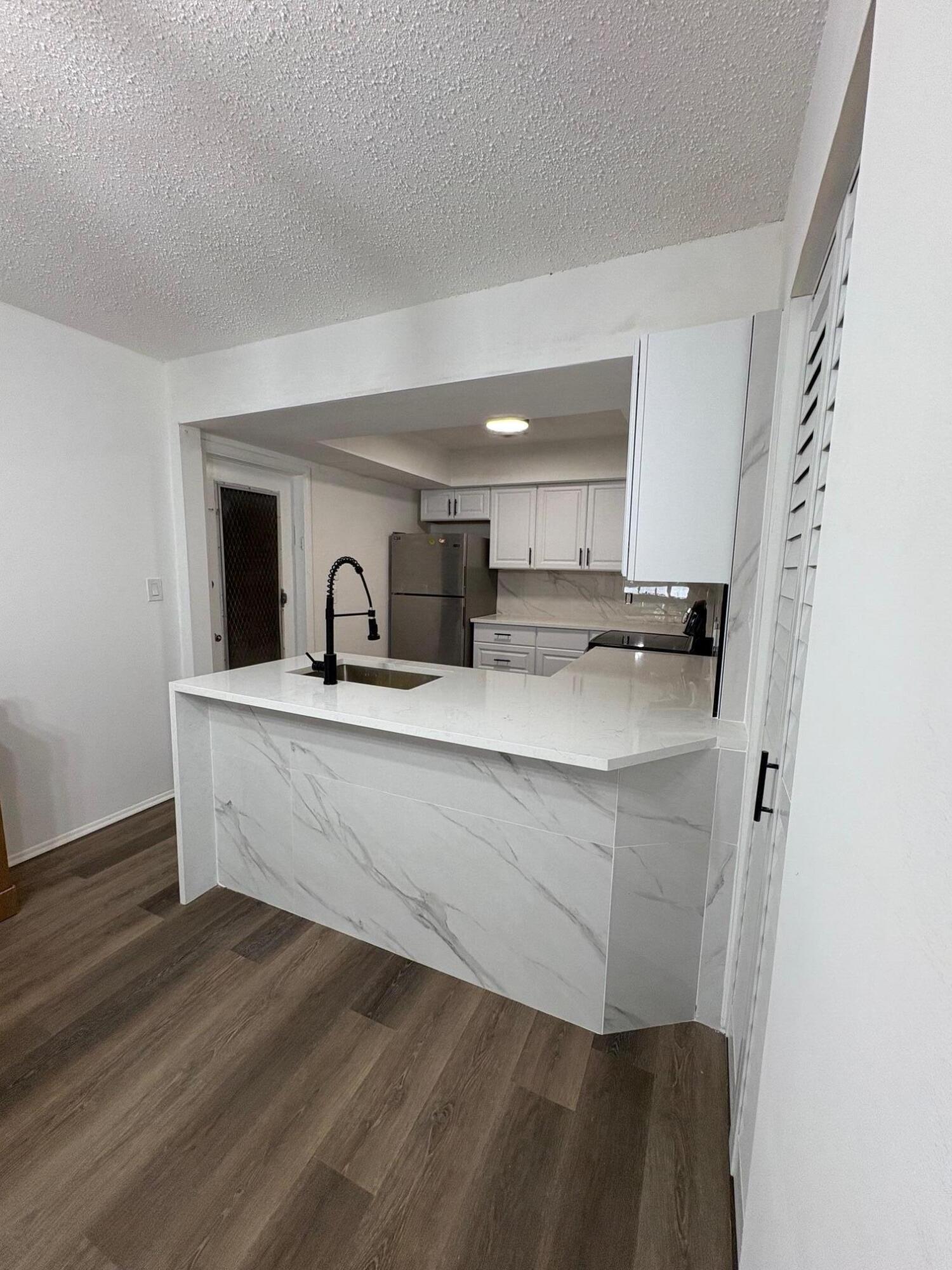 1150 East Sample Road, Unit 312 Pompano Beach, FL 33064 - Photo 2 of 11 a room with sink and mirror