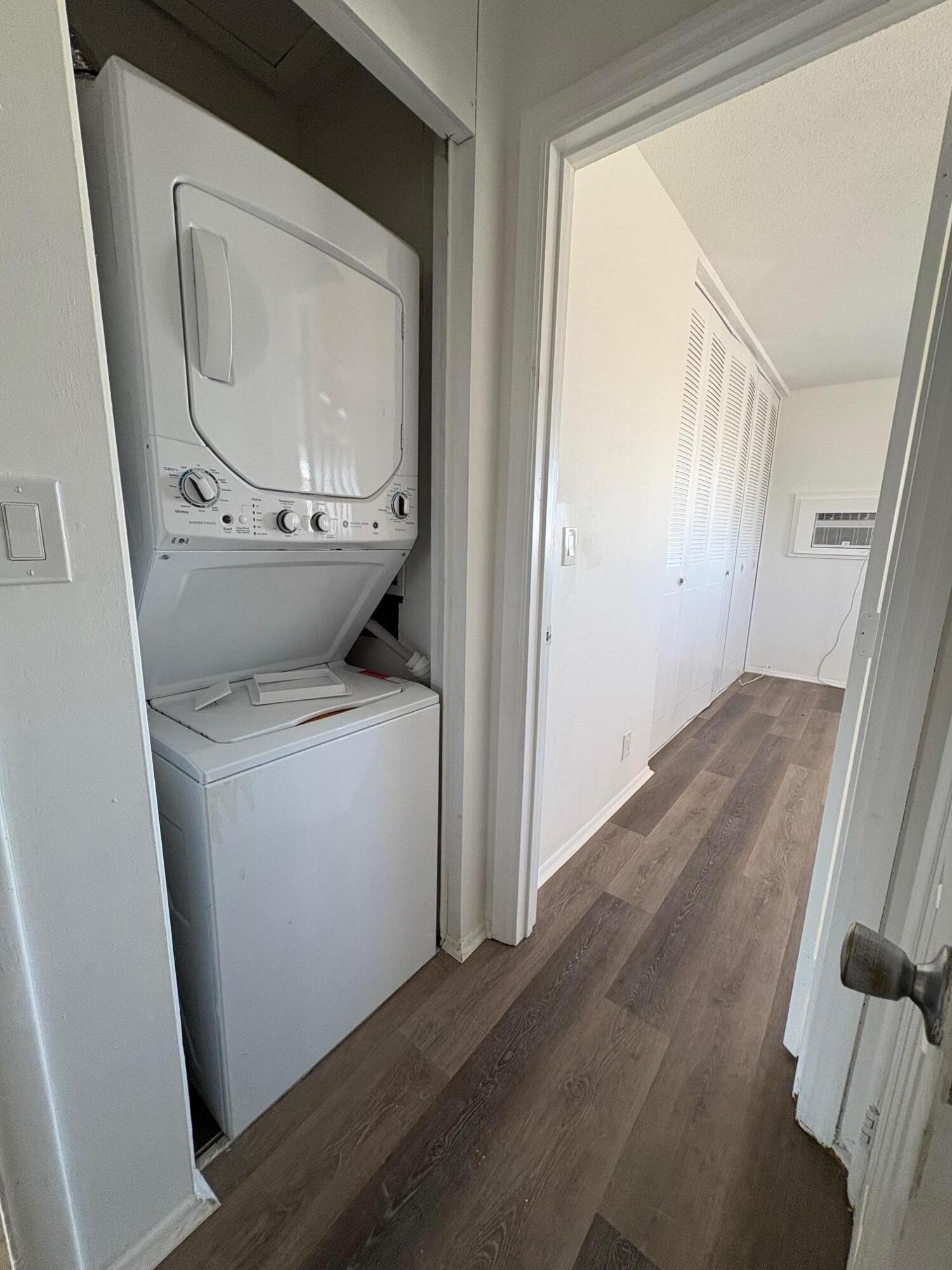 1150 East Sample Road, Unit 312 Pompano Beach, FL 33064 - Photo 4 of 11 a utility room with wooden floor washer and dryer