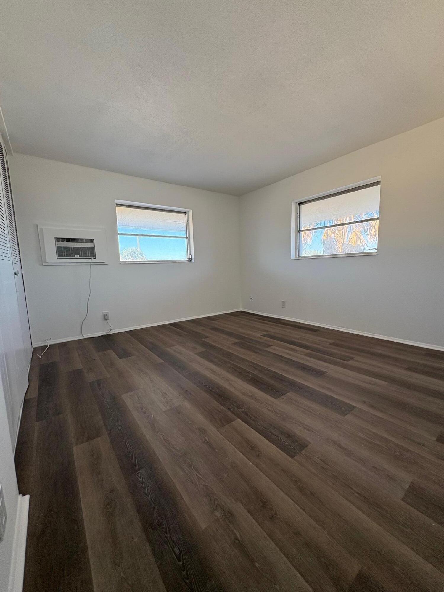1150 East Sample Road, Unit 312 Pompano Beach, FL 33064 - Photo 8 of 11 a view of a room with wooden floor and window