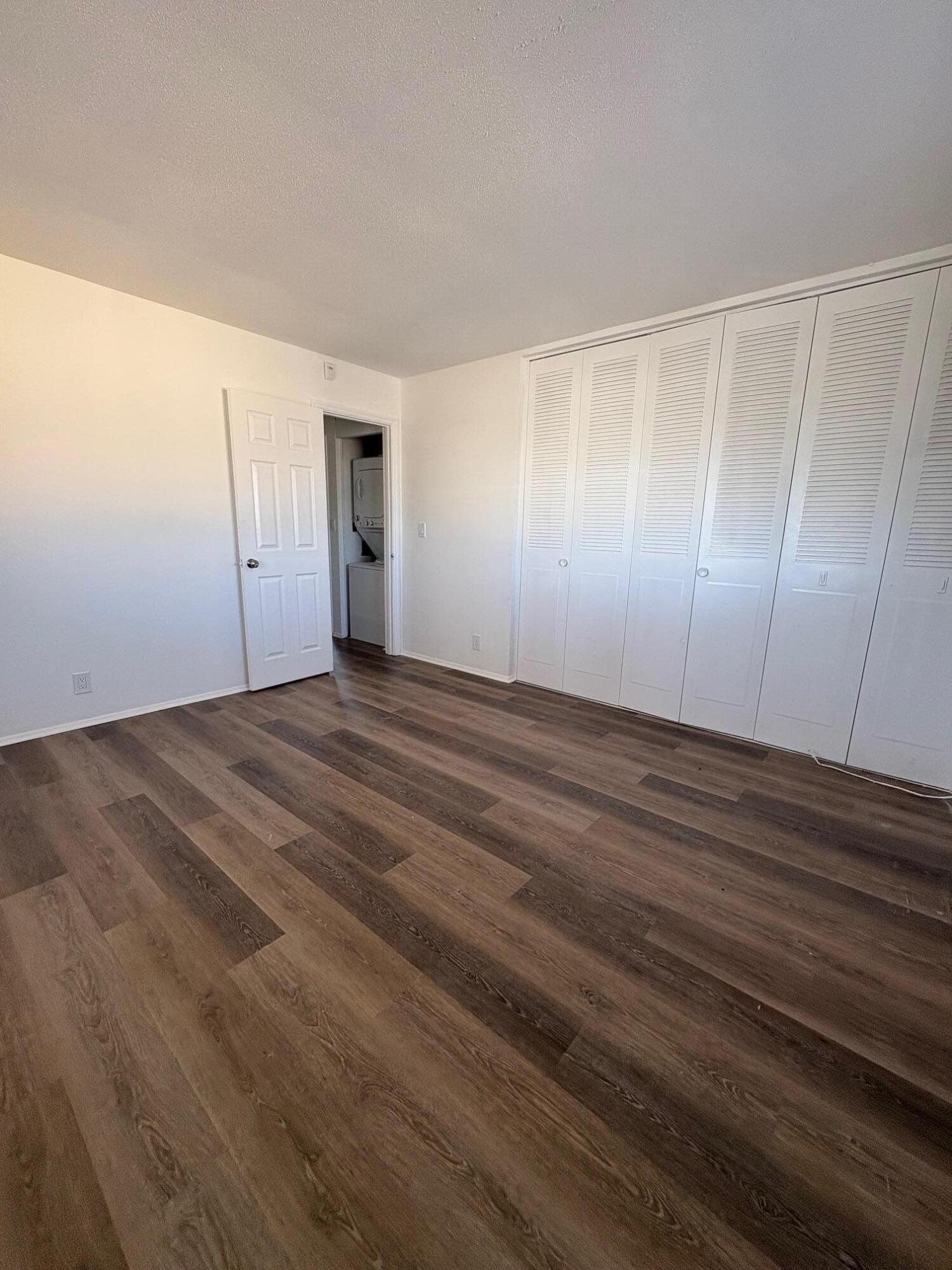 1150 East Sample Road, Unit 312 Pompano Beach, FL 33064 - Photo 9 of 11 a view of an empty room with wooden floor