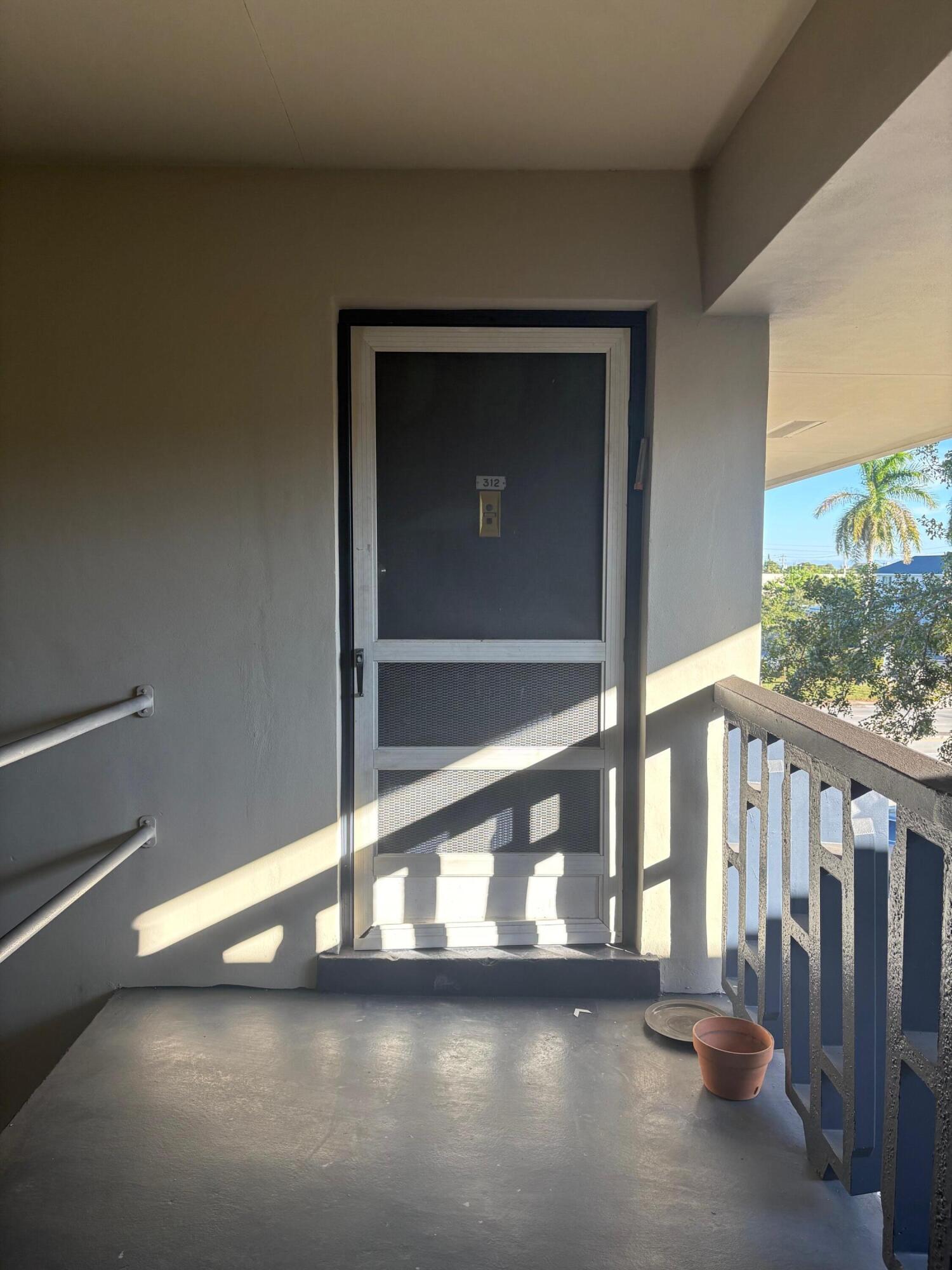1150 East Sample Road, Unit 312 Pompano Beach, FL 33064 - Photo 10 of 11 a view of empty room with floor to ceiling window