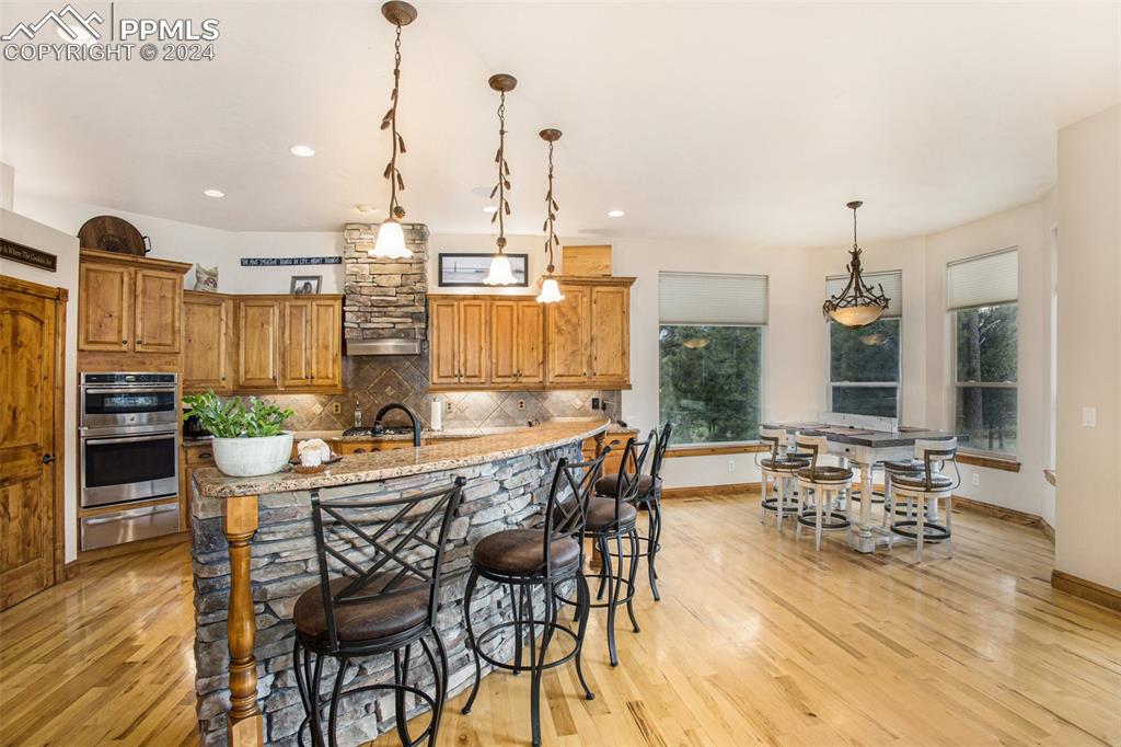 11628 Shaugnessy Road Colorado Springs, CO 80908 - Photo 12 of 50 a view of a dining room with furniture window and wooden floor