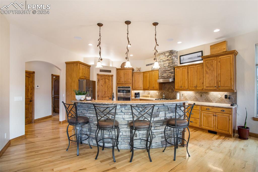 11628 Shaugnessy Road Colorado Springs, CO 80908 - Photo 15 of 50 a dining table with chairs and view of kitchen