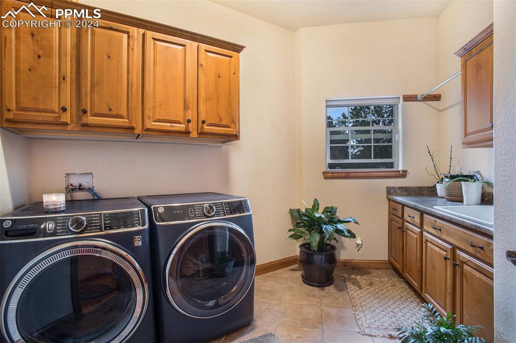 11628 Shaugnessy Road Colorado Springs, CO 80908 - Photo 16 of 50 a kitchen with sink a washer and dryer