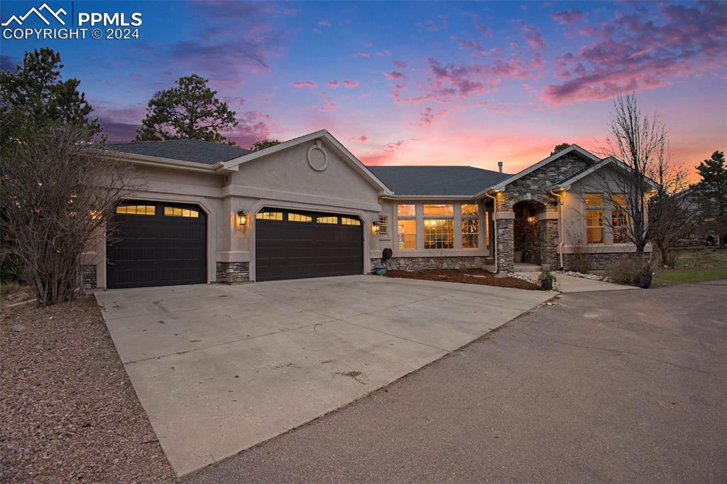 11628 Shaugnessy Road Colorado Springs, CO 80908 - Photo 2 of 50 a front view of a house with a yard and garage