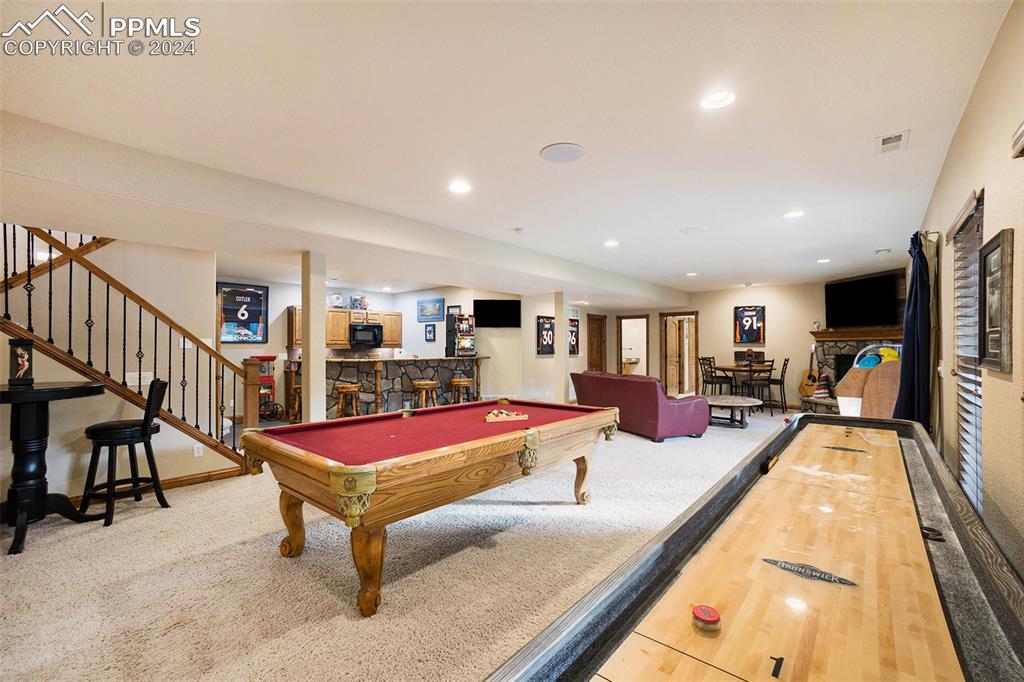 11628 Shaugnessy Road Colorado Springs, CO 80908 - Photo 21 of 50 a living room with furniture pool table and a flat screen tv