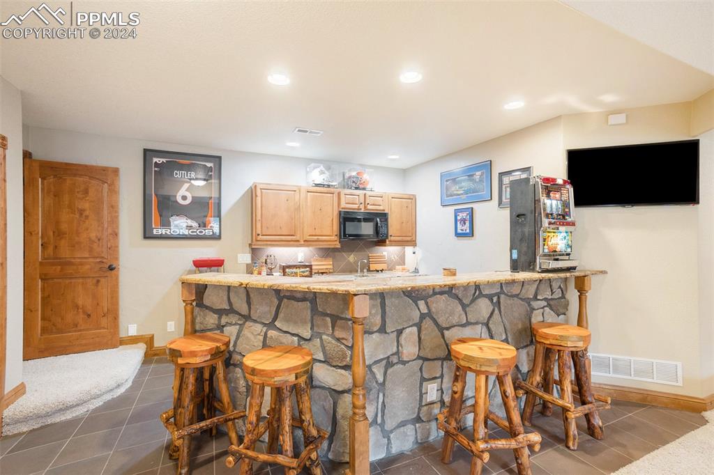 11628 Shaugnessy Road Colorado Springs, CO 80908 - Photo 25 of 50 a view of a dining room with furniture