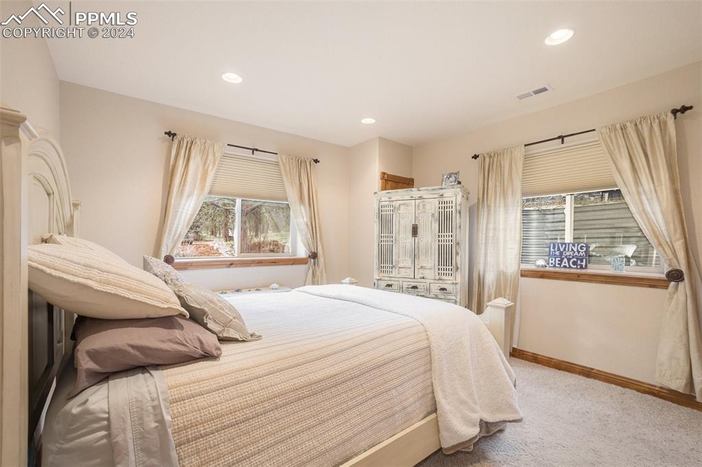 11628 Shaugnessy Road Colorado Springs, CO 80908 - Photo 28 of 50 a bedroom with a bed and a window