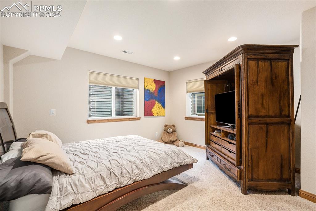 11628 Shaugnessy Road Colorado Springs, CO 80908 - Photo 29 of 50 a bedroom with a bed and a television