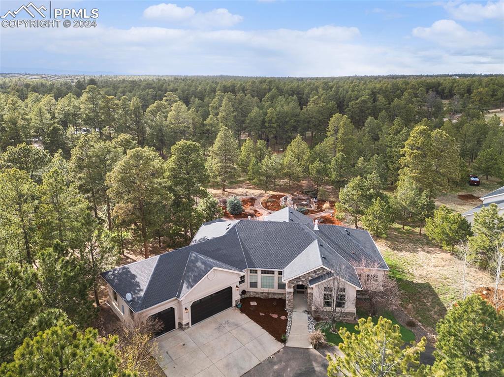 11628 Shaugnessy Road Colorado Springs, CO 80908 - Photo 3 of 50 a view of a house with a yard