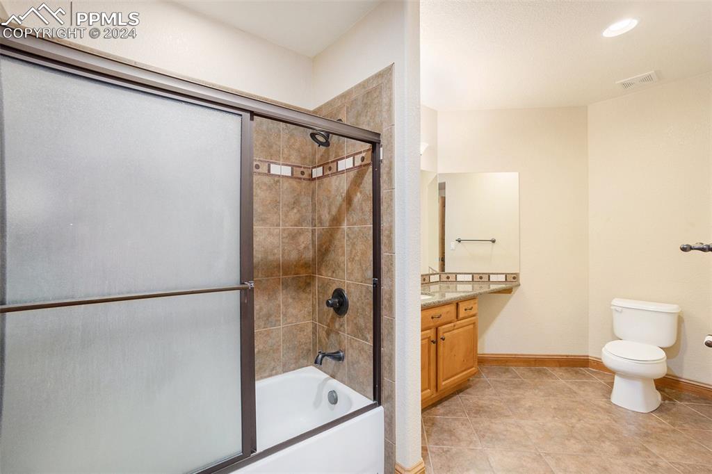 11628 Shaugnessy Road Colorado Springs, CO 80908 - Photo 31 of 50 a bathroom with a shower toilet and sink