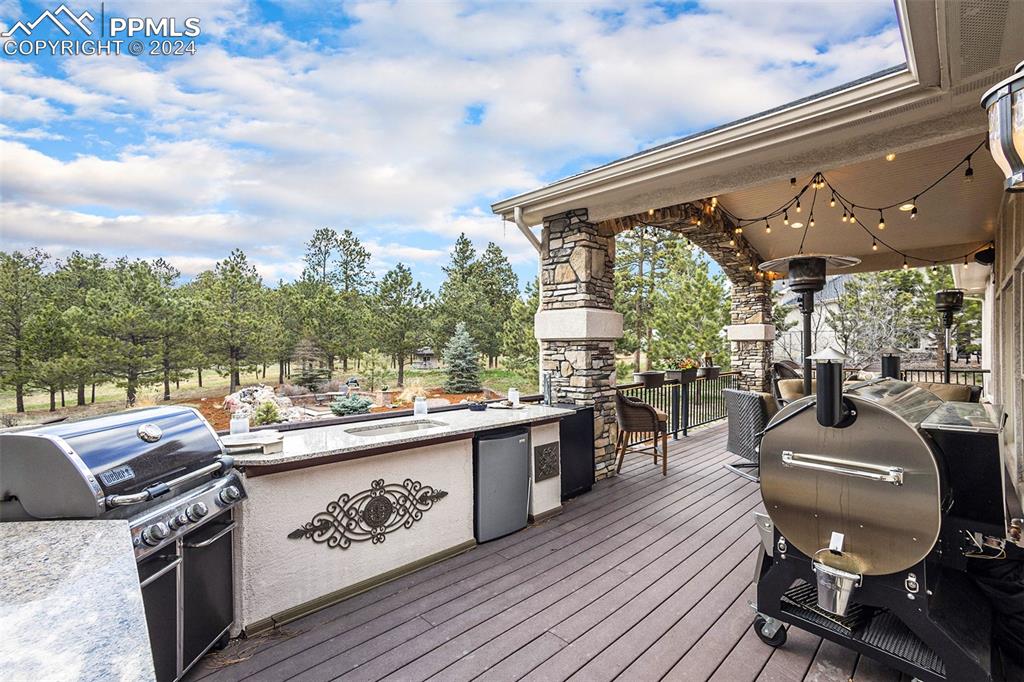 11628 Shaugnessy Road Colorado Springs, CO 80908 - Photo 32 of 50 a outdoor kitchen with a large window and chairs