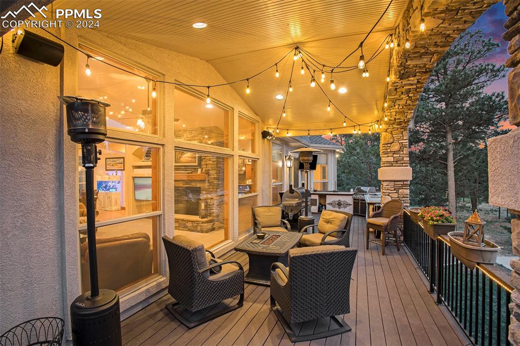 11628 Shaugnessy Road Colorado Springs, CO 80908 - Photo 33 of 50 a view of a patio with couches fire pit and a barbeque grill with dining table and chairs