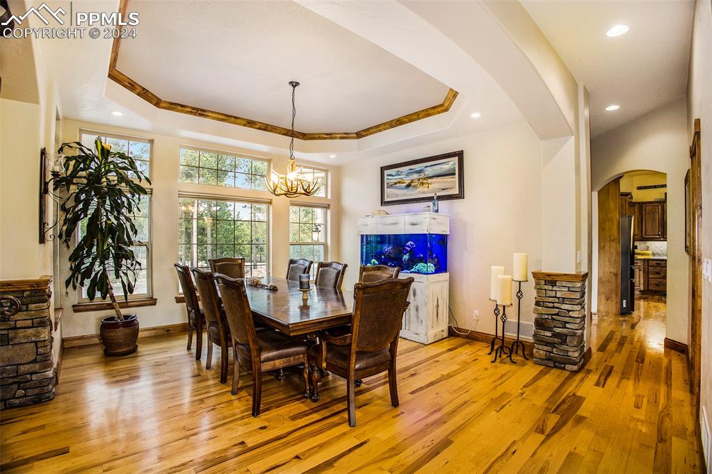 11628 Shaugnessy Road Colorado Springs, CO 80908 - Photo 10 of 50 a view of a dining room with furniture window and wooden floor