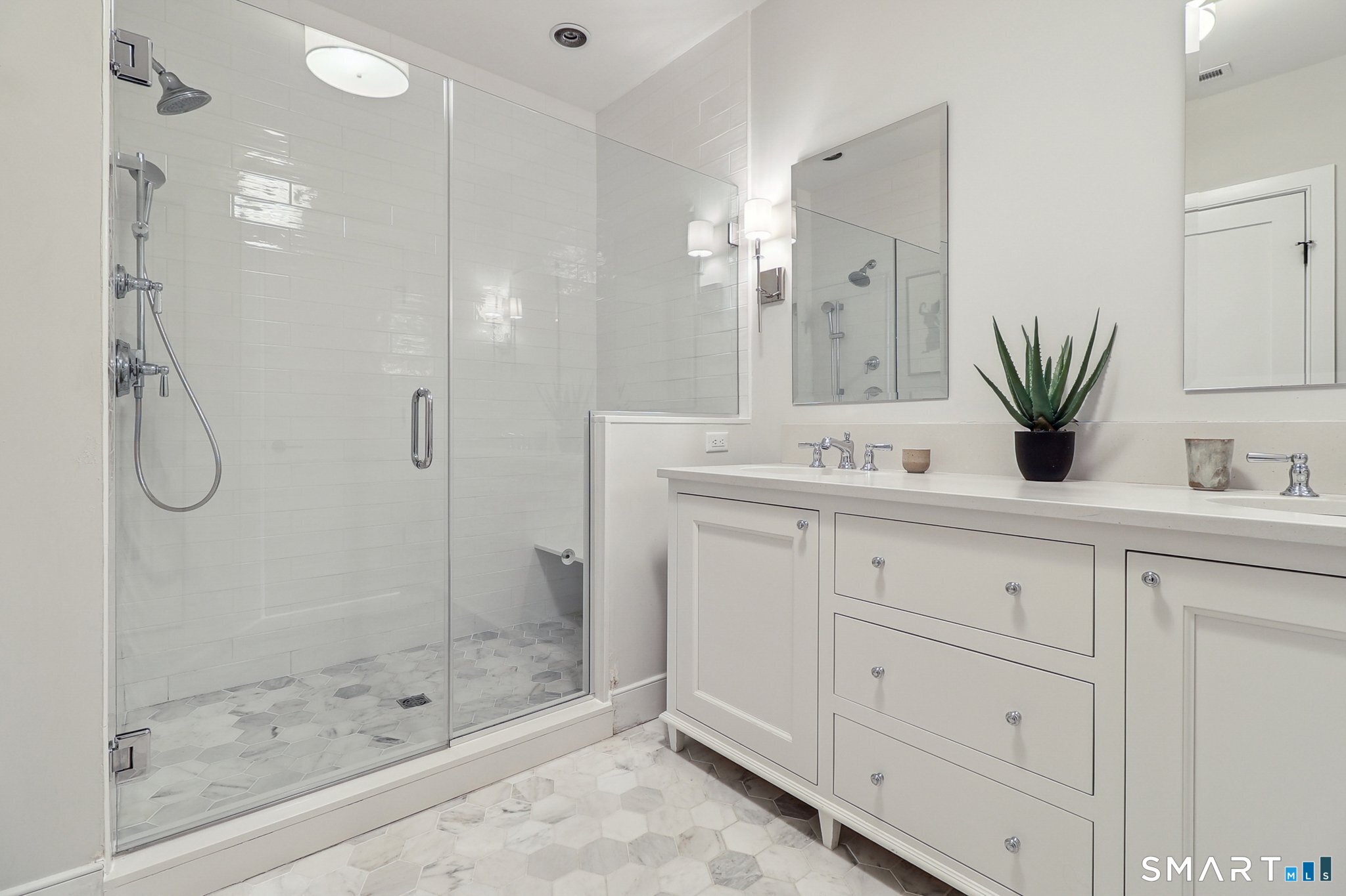 485 Westway Road, Unit 485 Fairfield, CT 06890 - Photo 21 of 39 a bathroom with a shower sink and mirror