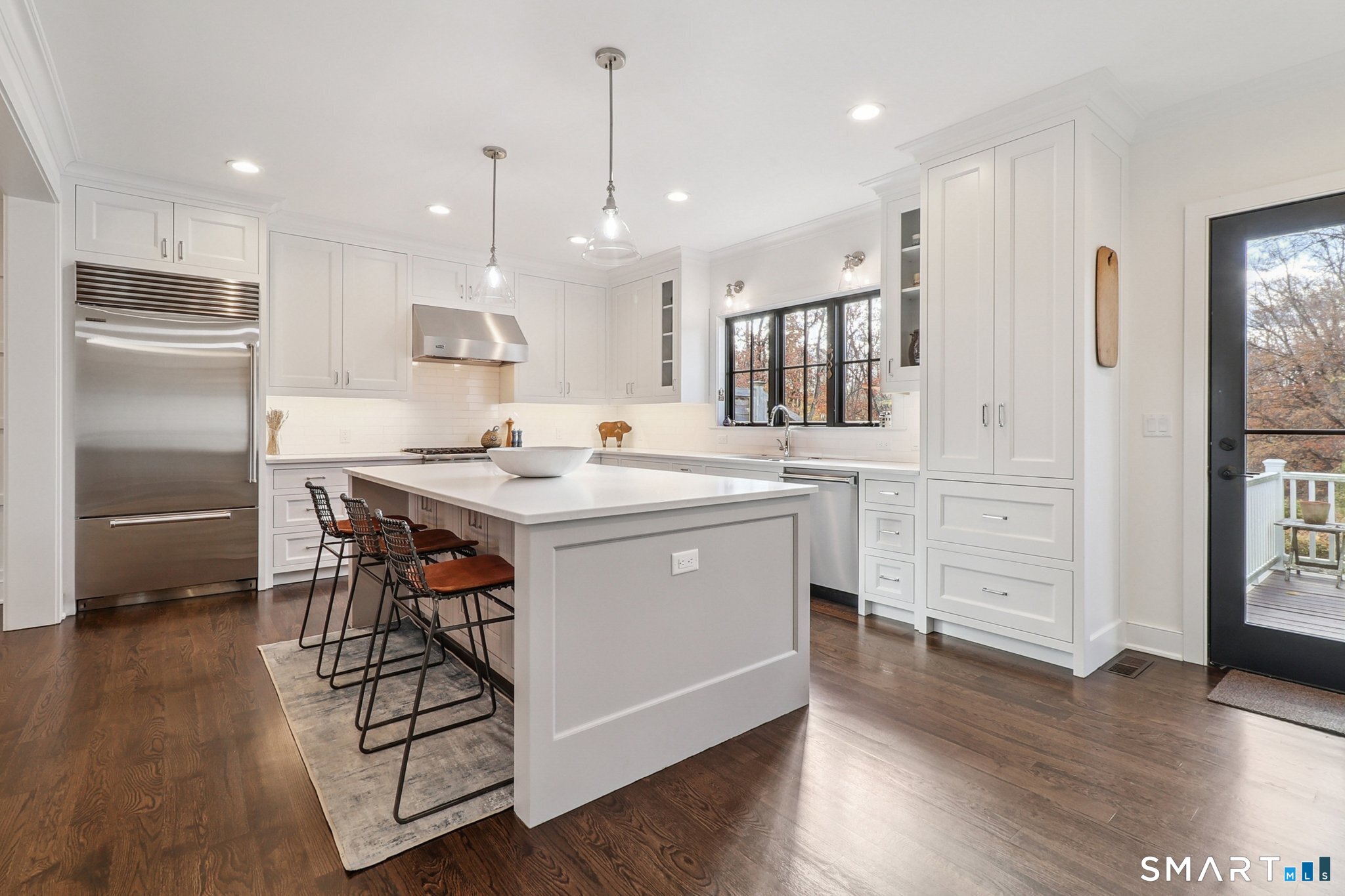 485 Westway Road, Unit 485 Fairfield, CT 06890 - Photo 9 of 39 a kitchen with stainless steel appliances kitchen island granite countertop a stove a sink a refrigerator and white cabinets with wooden floor