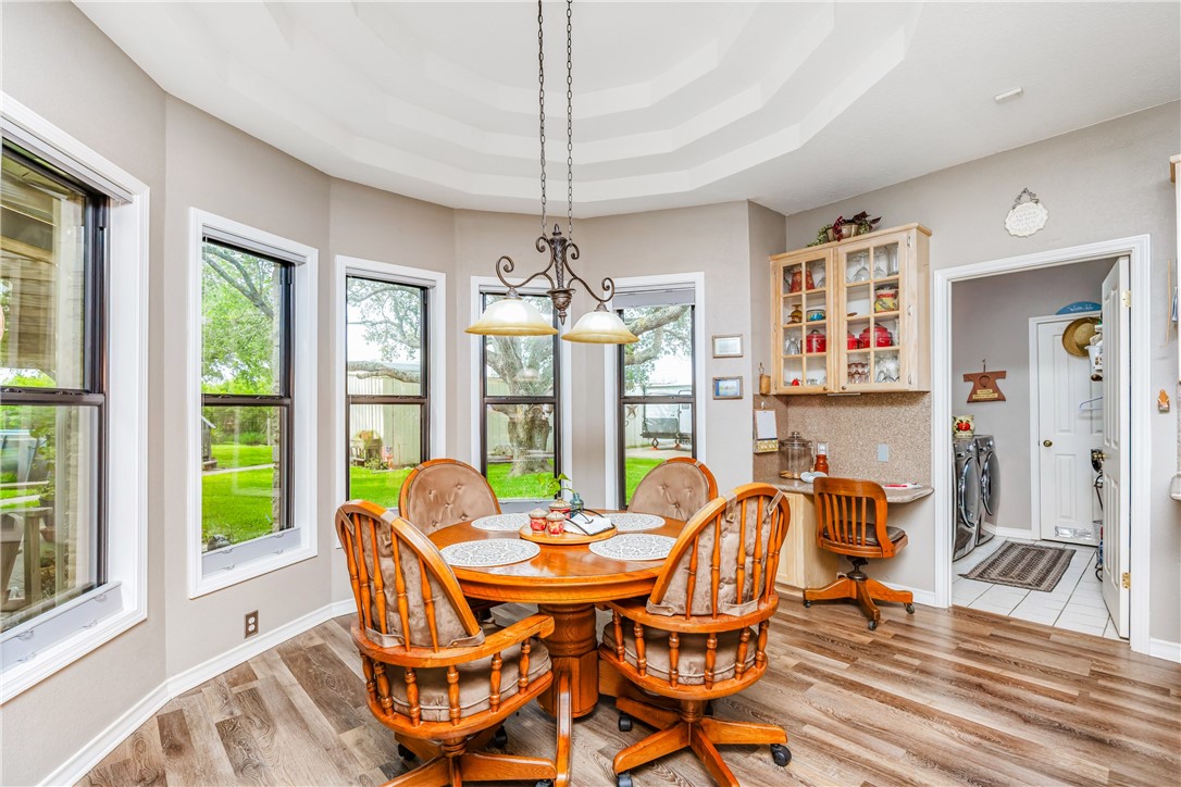 345 Trail Ridge Drive Sandia, TX 78383 - Photo 22 of 40 a dining room with furniture a chandelier and wooden floor