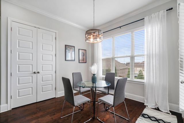 a dining room with wooden floor and breakfast area
