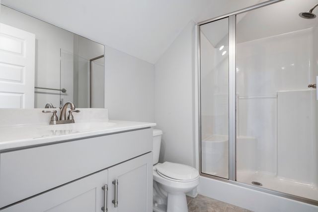 a bathroom with a sink toilet vanity and shower
