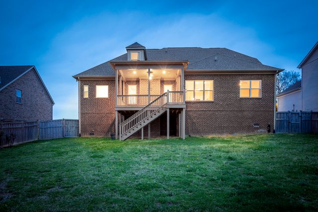 a view of a house with a small yard and a large window