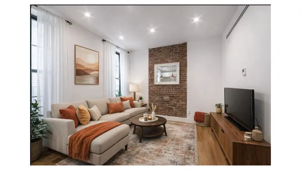 a living room with furniture a flat screen tv and a fireplace