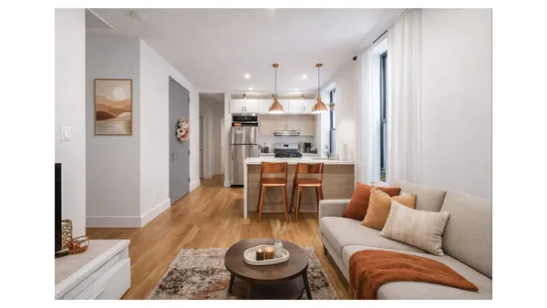 a living room with furniture and a dining table
