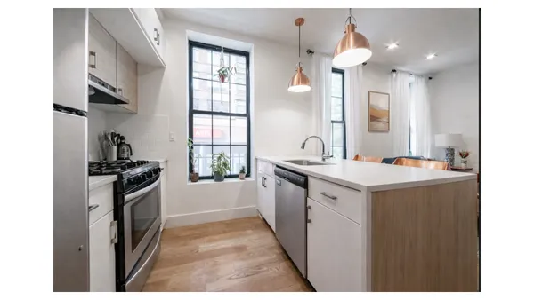a kitchen with a sink stove and refrigerator