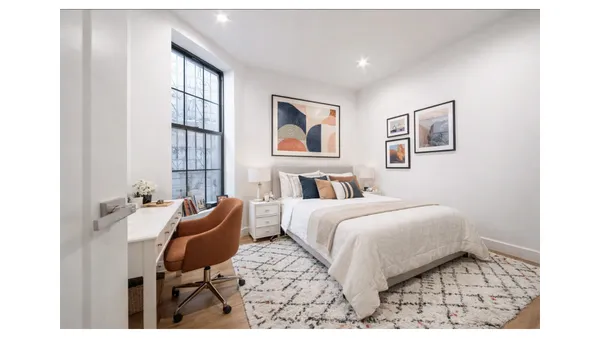 a bedroom with a bed and a chair