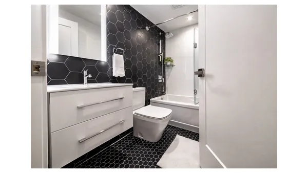 a bathroom with a toilet a sink and a mirror