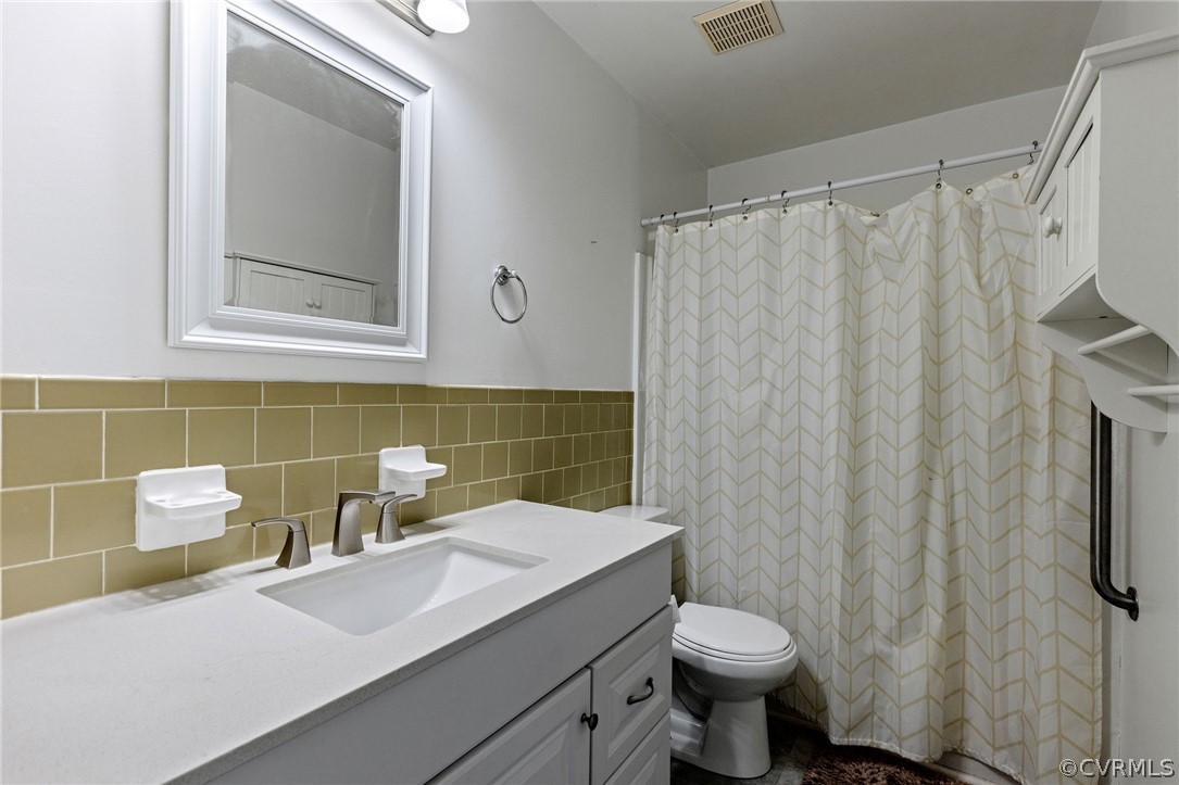 1413 Ransco Road North Chesterfield, VA 23235 - Photo 19 of 24 a bathroom with a sink a toilet and shower curtain