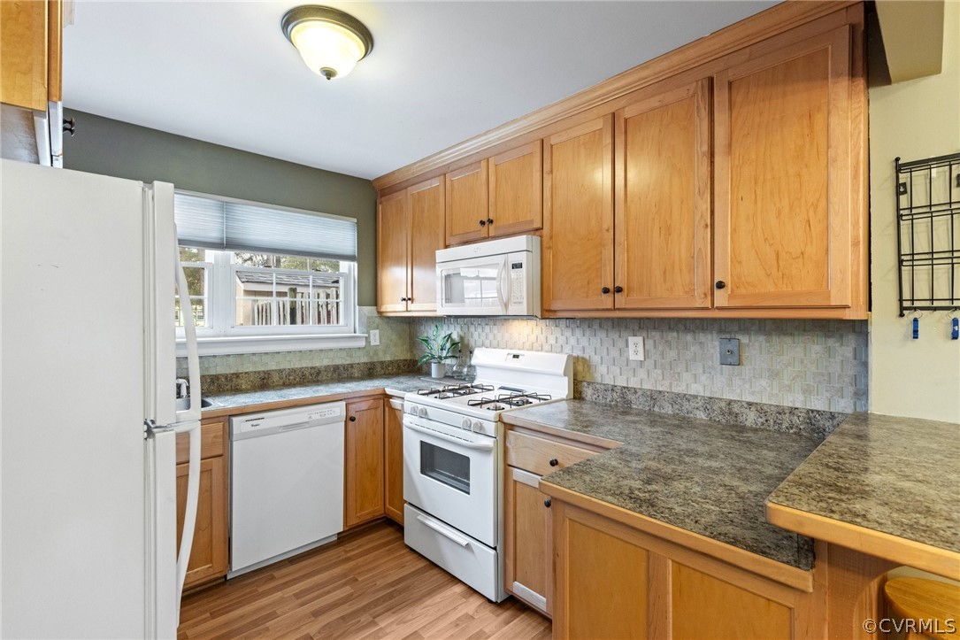 1413 Ransco Road North Chesterfield, VA 23235 - Photo 10 of 24 a kitchen with stainless steel appliances granite countertop a sink and cabinets with wooden floor