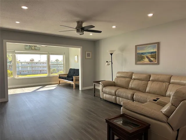 a living room with furniture and wooden floor