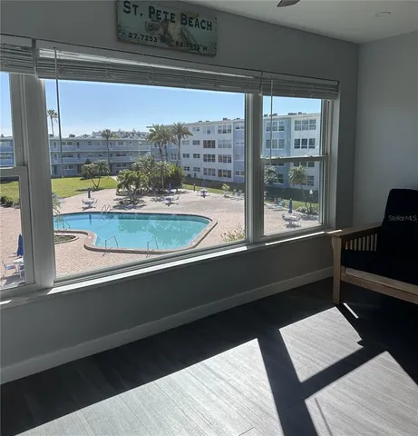 a view of a swimming pool and lounge chair