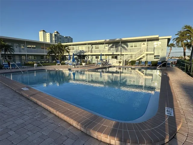 a view of a swimming pool with outdoor seating