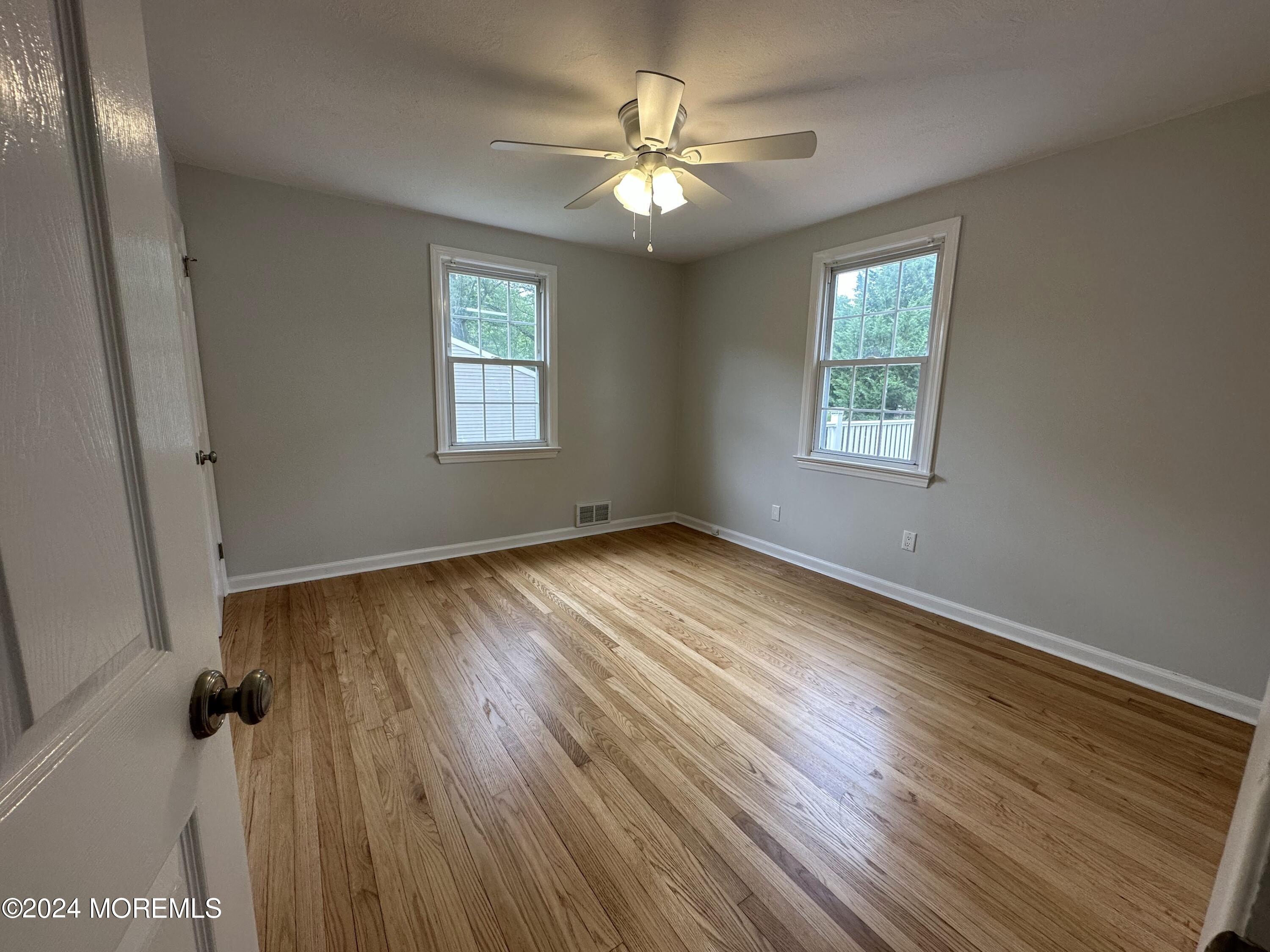 57 Kings Road Little Silver, NJ 07739 - Photo 14 of 22 a view of an empty room with wooden floor and a window
