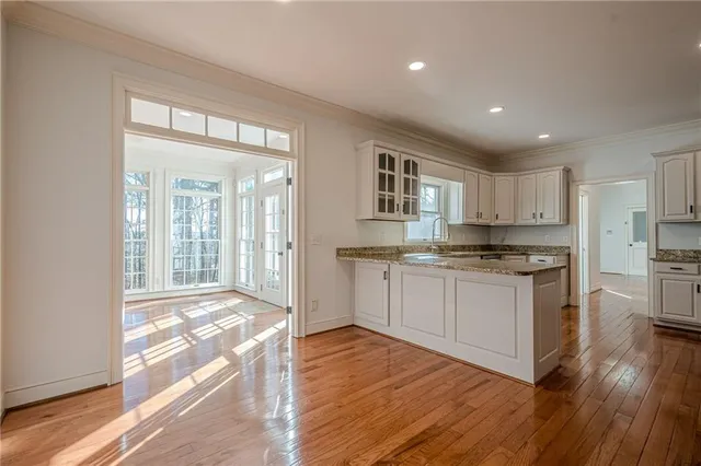 a view of empty room with wooden floor